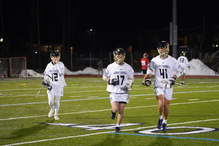 The Blue Streaks hustle off the field after a home game this season.