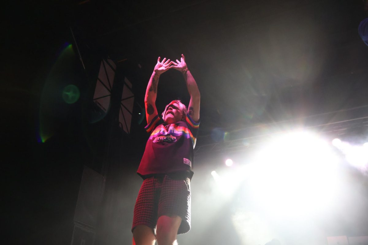 Sean Foreman signaling to the crowd with the signature 3OH3! hand sign. 