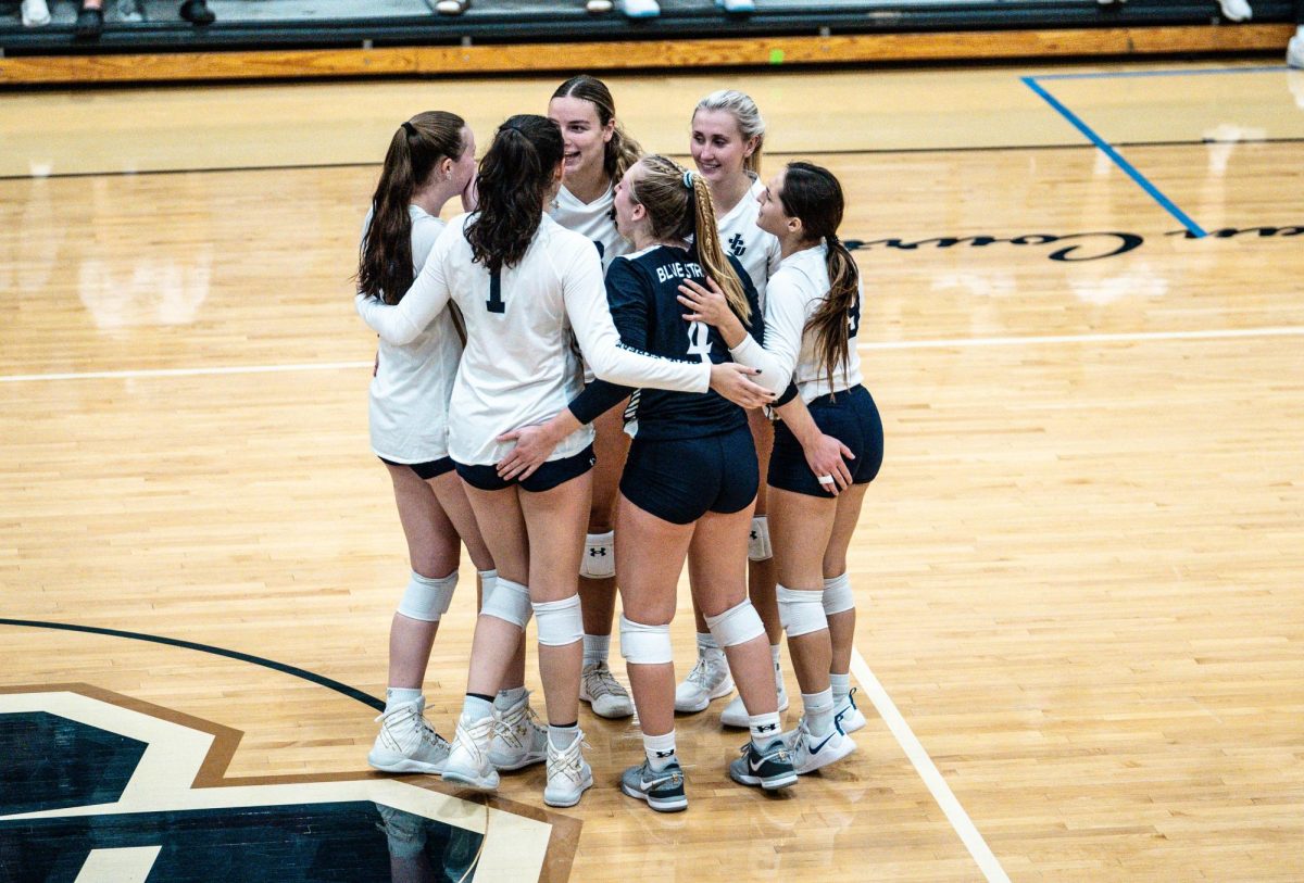 JCU Volleyball celebrates after securing a point in their latest match.
