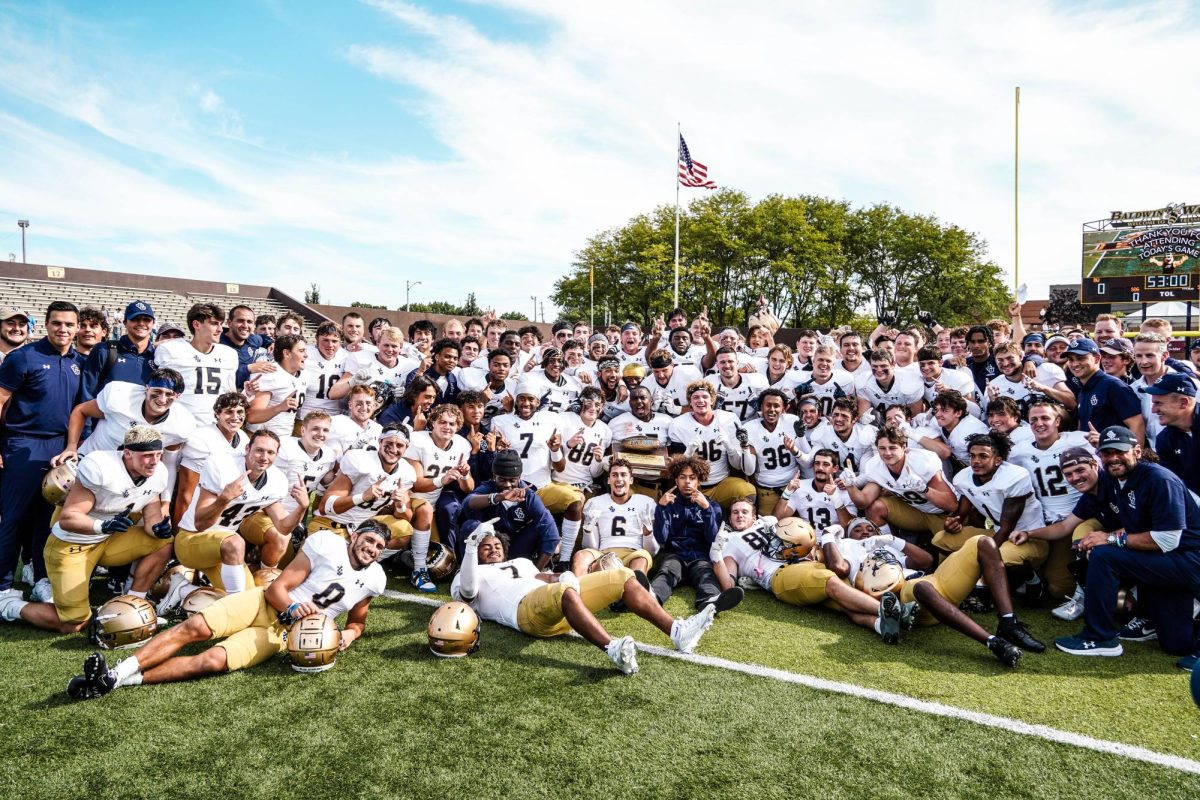 The football team celebrates after a road victory against Baldwin Wallace.
