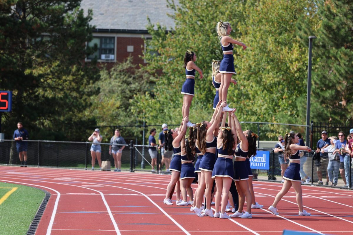 JCU cheerleaders motivate the crowd while performing stunts to rally the Blue Streaks!
