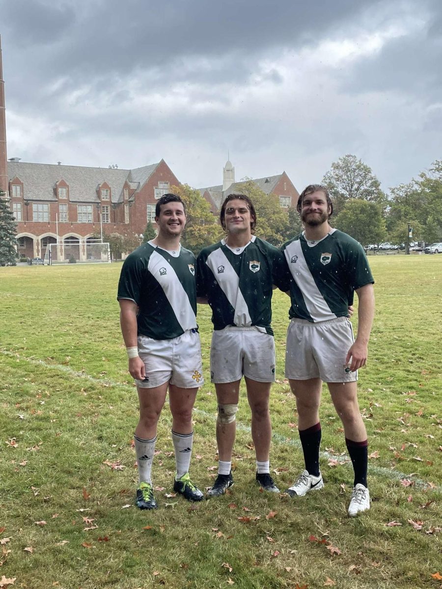 John Carroll club rugby players smile for a group picture following their win against Hillsdale.
