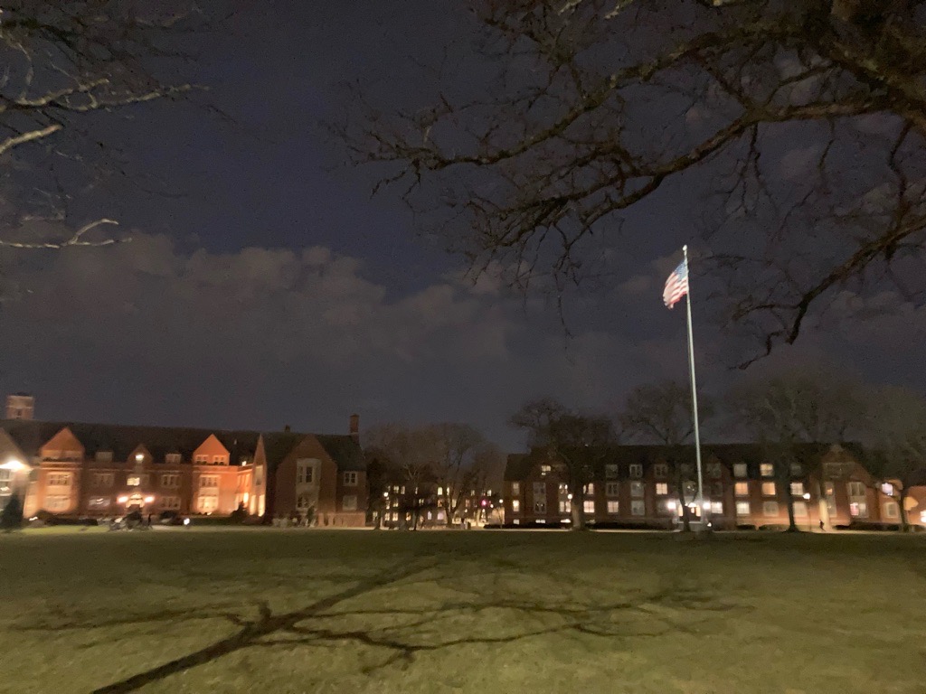The surrounding lights assist with illuminating the American flag. Strong winds help the flag and show its colors to the JCU Community.