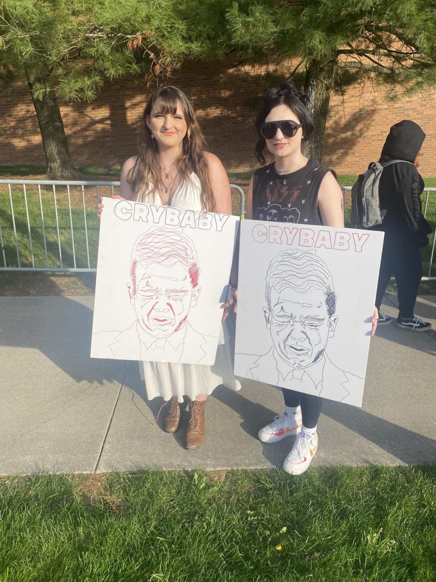 Two anonymous Protesters with their artworks
