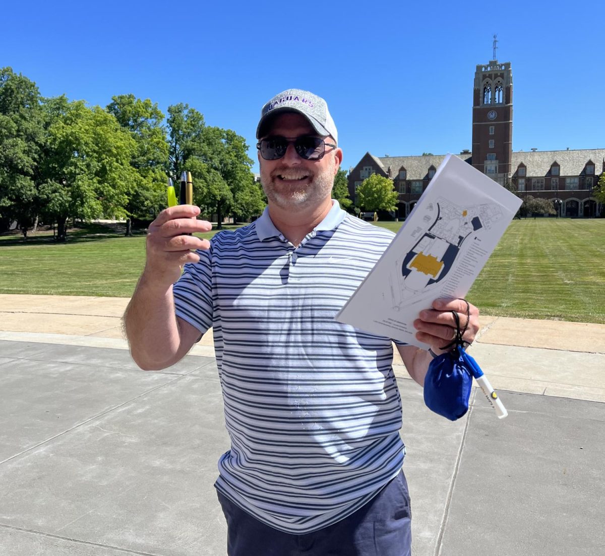 Bella Congelio's dad poses for a picture with all the free stuff he got at her freshman year orientation. 