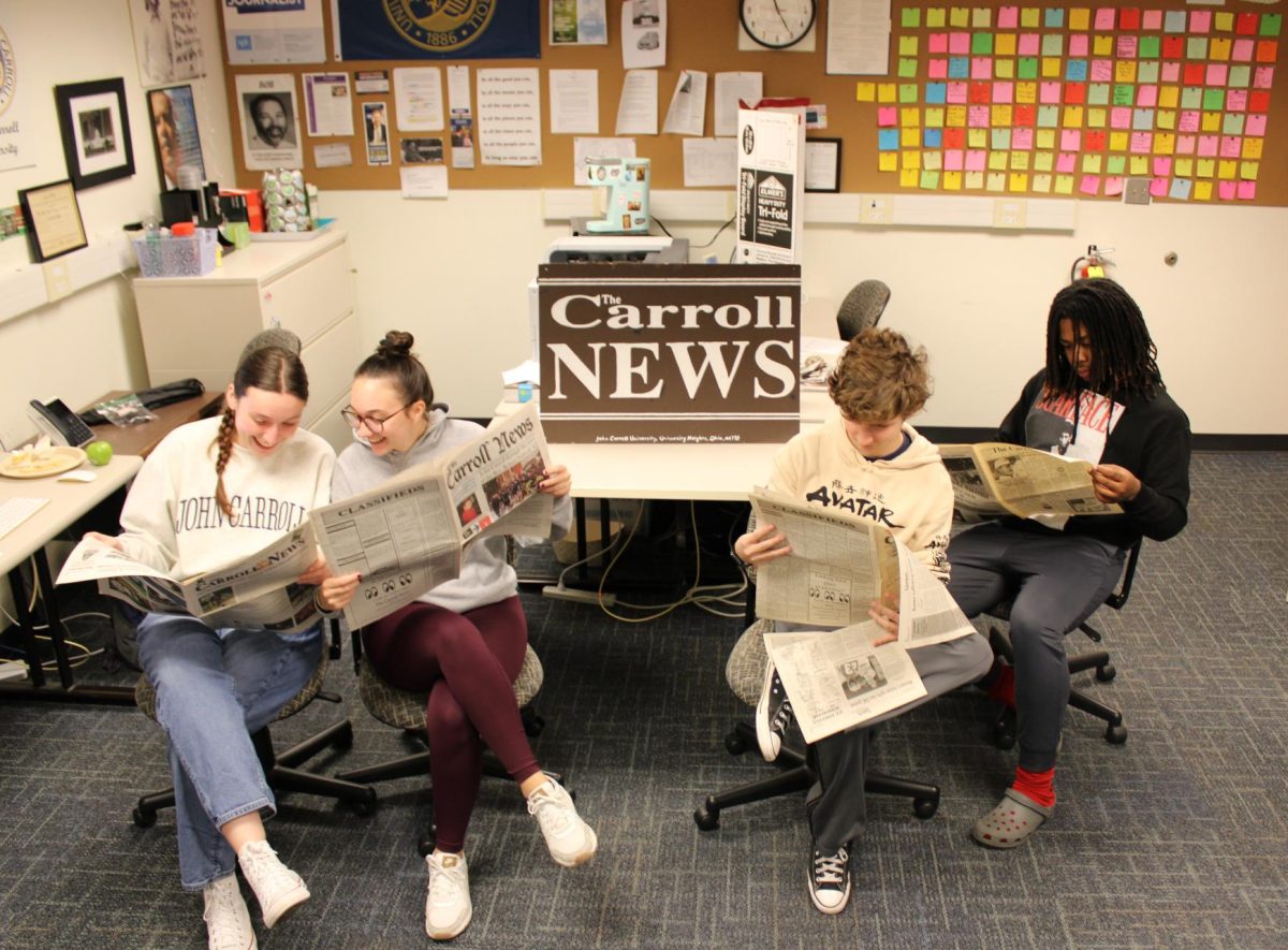 Current editors read past editions of The Carroll News to prepare for its return to print. 