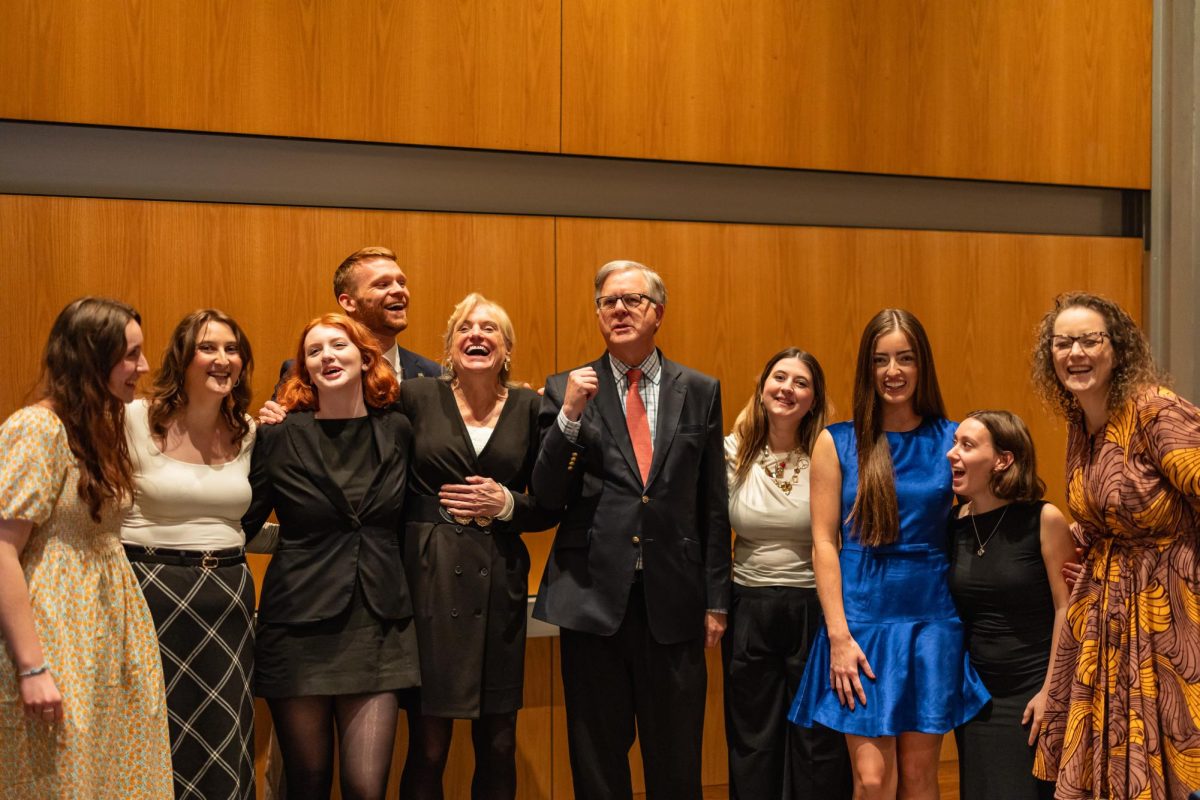 Linda Meglin ’74, Pete Williams and Malia McAndrew pose with students who helped  develop the Tim Russert Collection 