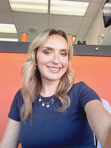 John Carroll alumna Ashley Bastock sits in the Cleveland Browns media box 