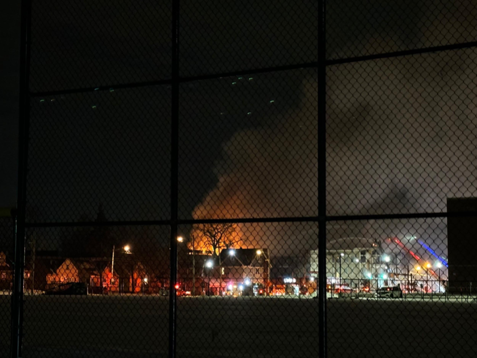 A closer look at the catastrophe, through the fenceline of the adjacent Cleveland Heights High School