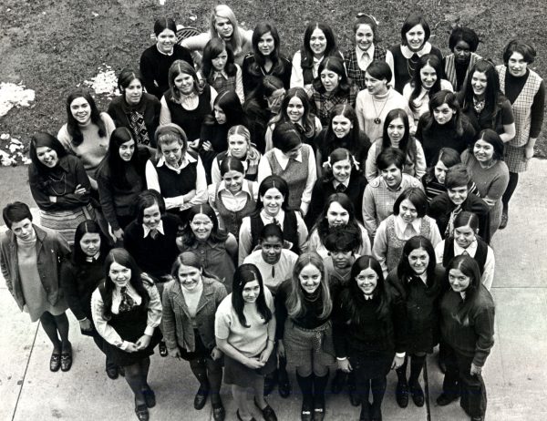 Some of the first women to graduate from John Carroll University smile for a picture. 