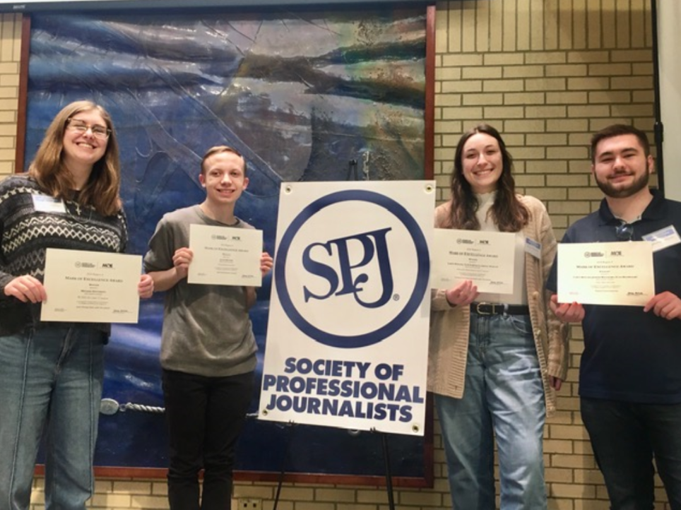 From left to right, Editor-in-Chief Grace Sherban ’25, Campus Editor Jacob Meyers ’28, Arts & Life Editor Anna Maxwell ’27 and Community Editor Michael Walsh ’25 accept awards. 