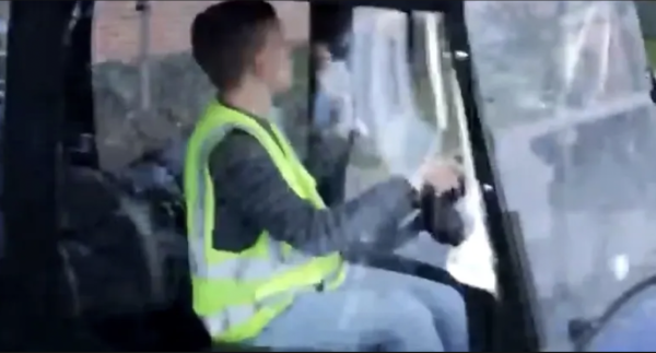 Jacob Meyers drives a golf cart around John Carroll University's campus. 